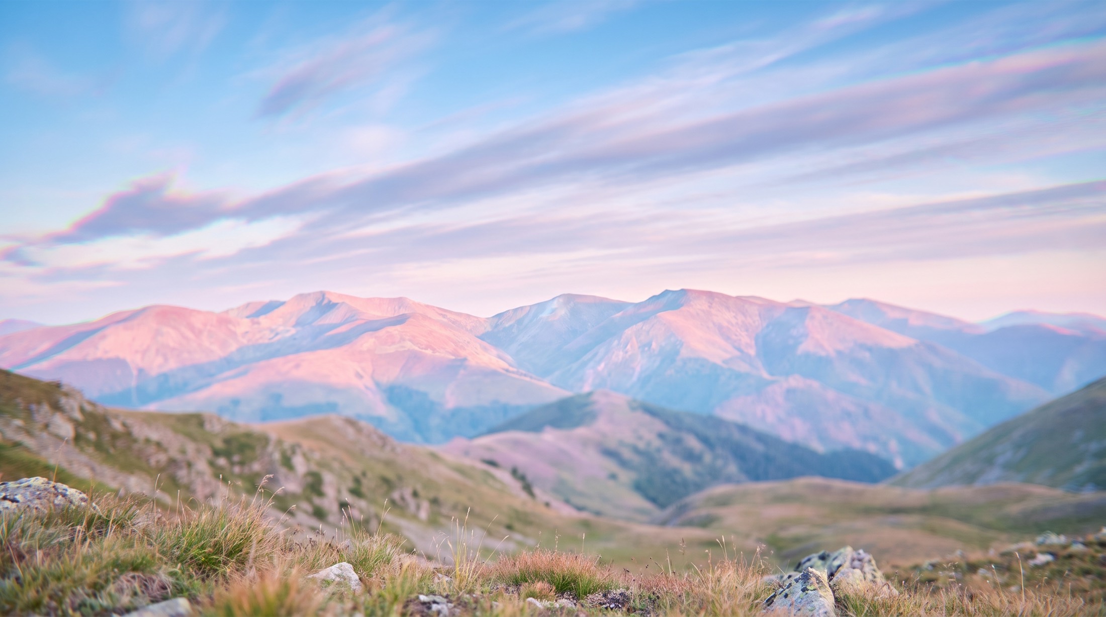 Mountain ridge at dusk under long-exposure clouds